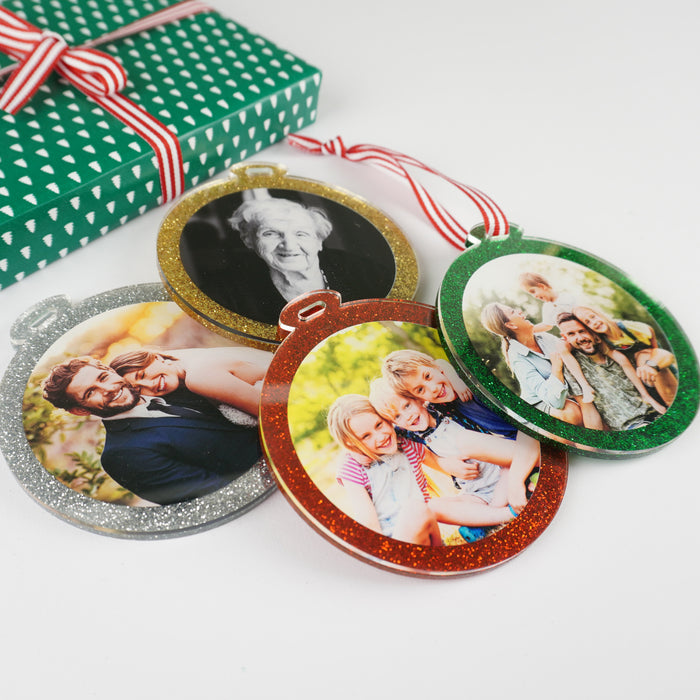 Glitter acrylic Christmas ornament with candy-striped hanging ribbon