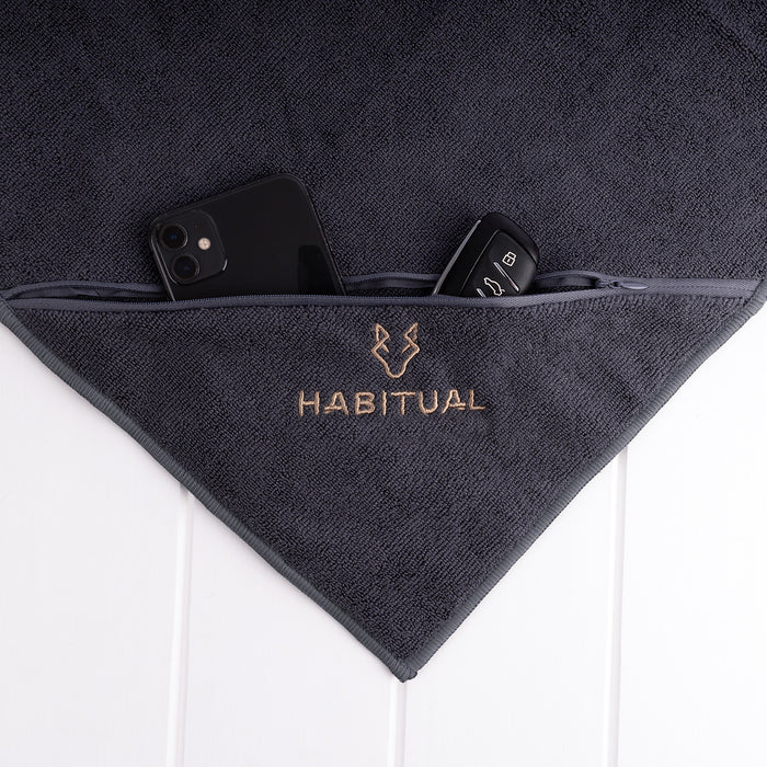 Charcoal gym towel with custom embroidered logo and storage pocket