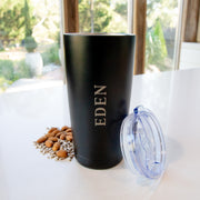 Black vacuum-insulated travel mug keeping drinks hot or cold for up to 12 hours