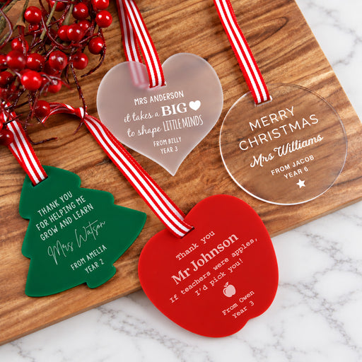 Personalised acrylic teacher Christmas decorations in frosted, clear, green and red designs.