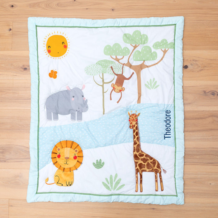 Safari-themed cot blanket laid flat, showcasing vibrant jungle animals and personalised detail.