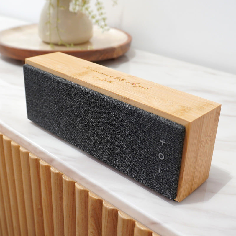 Personalised bamboo Bluetooth speaker laser engraved with a custom name or message.
