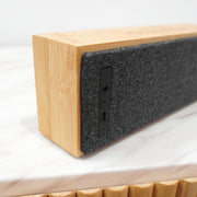 Personalised wireless Bluetooth speaker with laser engraved bamboo top, perfect for home or office use.