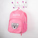 Pink personalised kids backpack with embroidered child's name and smiling koala face print.