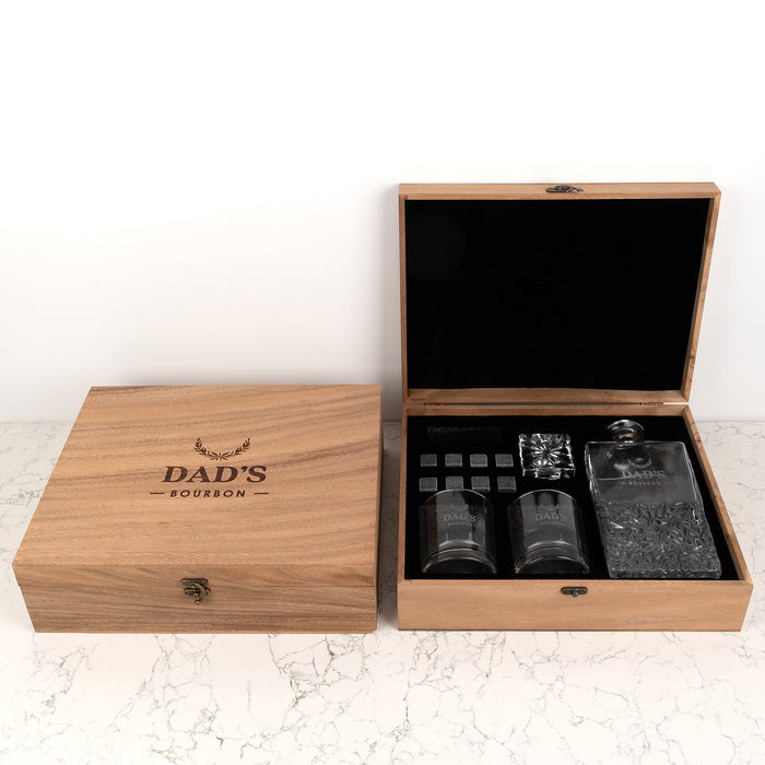 Engraved whiskey decanter, glasses, and stones set presented in a wooden gift box.