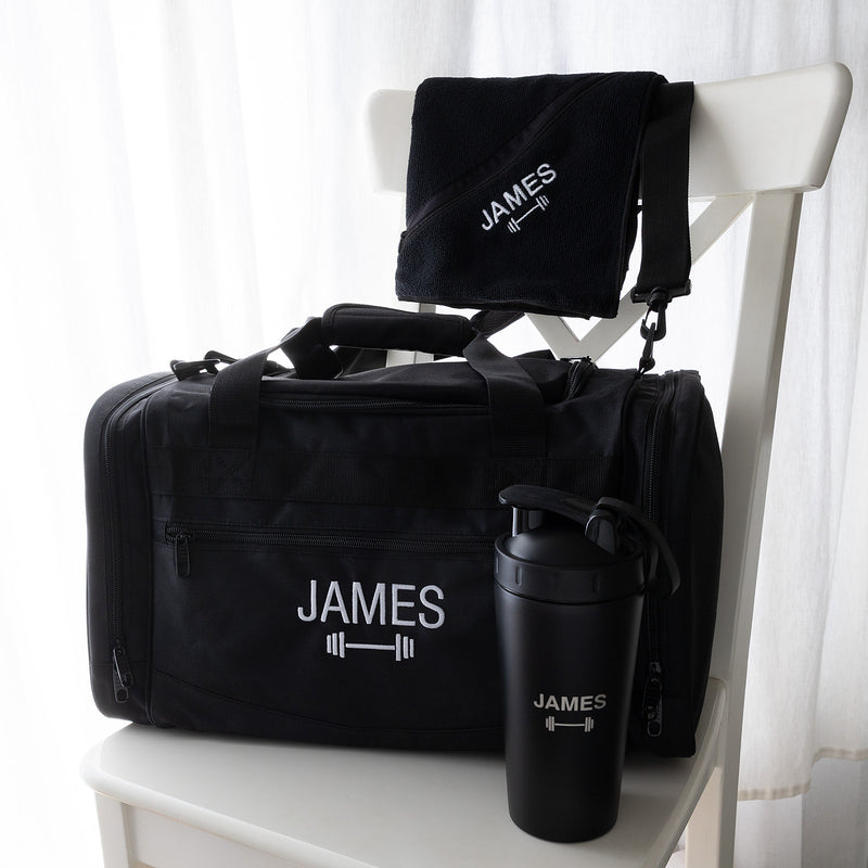 Personalised gym hamper with an embroidered sports bag, engraved protein shaker and matching black gym towel.