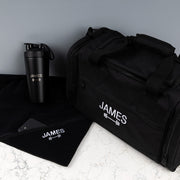 Personalised workout hamper including an embroidered sports bag, laser engraved protein shaker and matching black gym towel for fitness lovers.