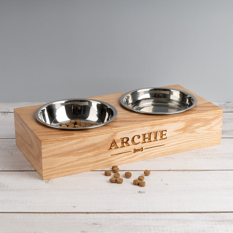 Personalised wooden pet feeding station engraved with pet’s name in solid oak