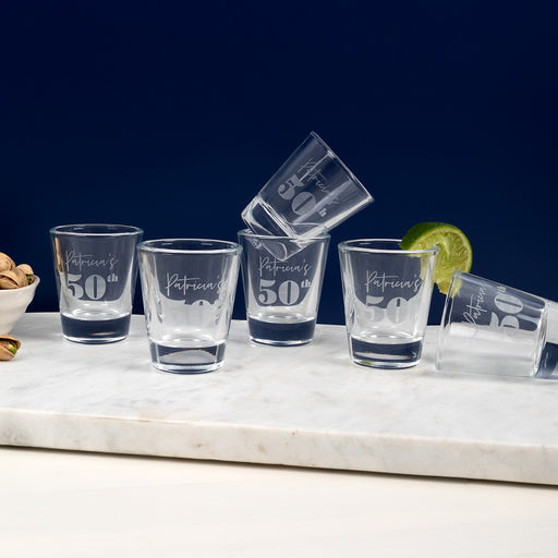 Personalised 50ml shot glass engraved with 50th birthday design, name, and date.