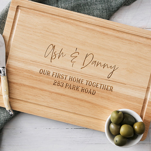 Custom housewarming cheese board made from natural wood, perfect for serving or display.