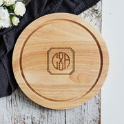 Custom housewarming cheese board made from natural wood, ideal for serving or display.