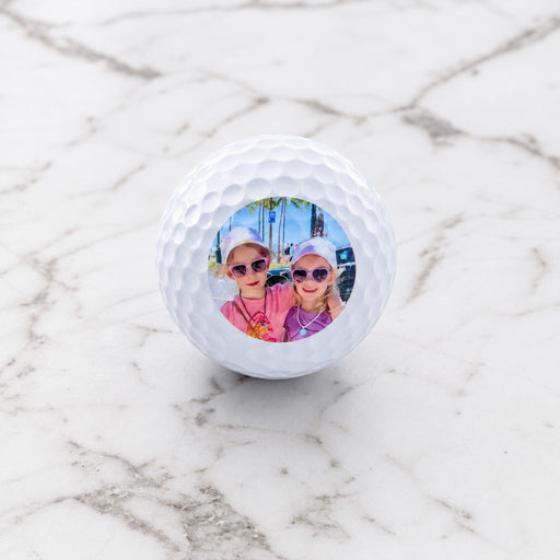 Close-up of custom golf balls printed with a photo, perfect gift for Father’s Day or birthdays.