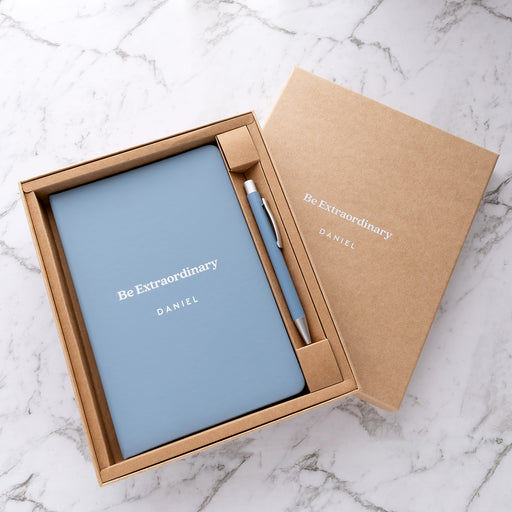 Personalised light blue notebook and pen gift set with white UV printed name in a premium kraft gift box