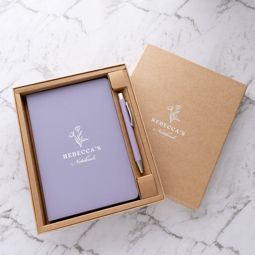 Personalised purple notebook and pen gift set with white UV printed name presented in a kraft gift box