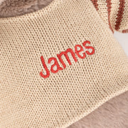 Custom embroidered reindeer toy with cosy knitwear, ideal for baby's first Christmas gift.