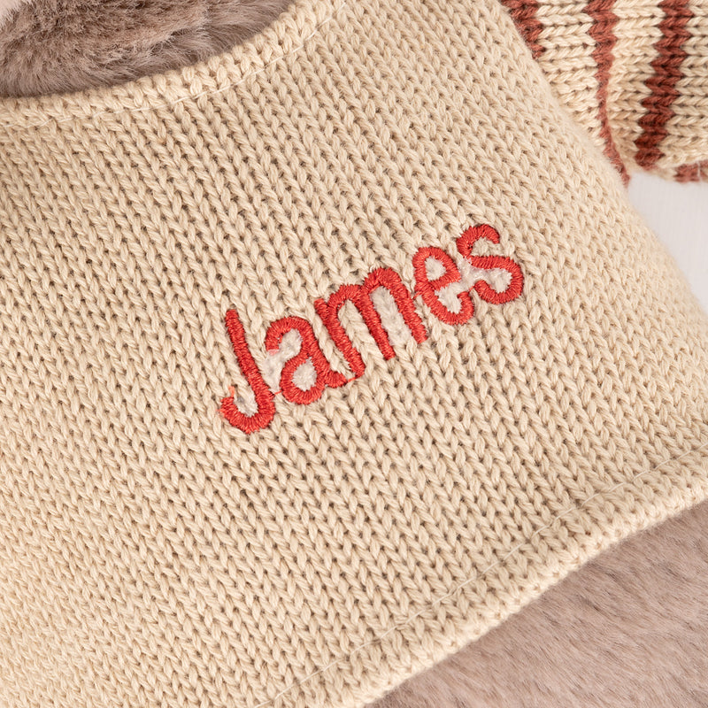 Custom embroidered reindeer toy with cosy knitwear, ideal for baby's first Christmas gift.