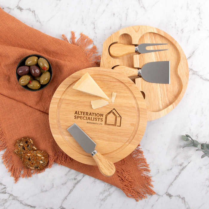 Branded wooden serving board used at business celebration with assorted cheeses and fruits