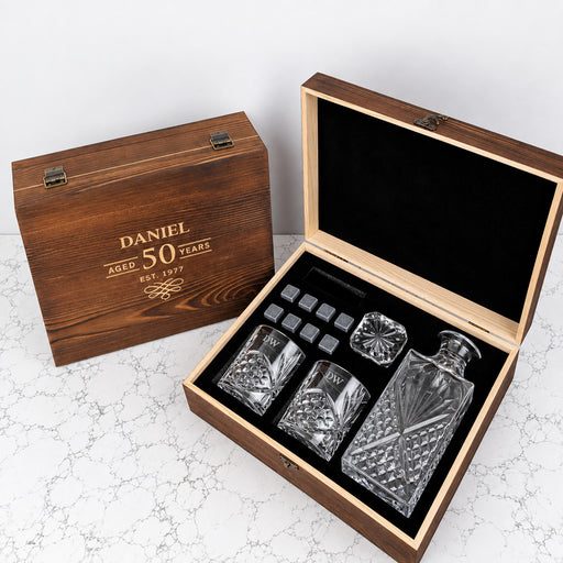 Personalised birthday whiskey gift set with 870ml decanter, two engraved scotch glasses and whiskey stones presented in a rustic wooden box.
