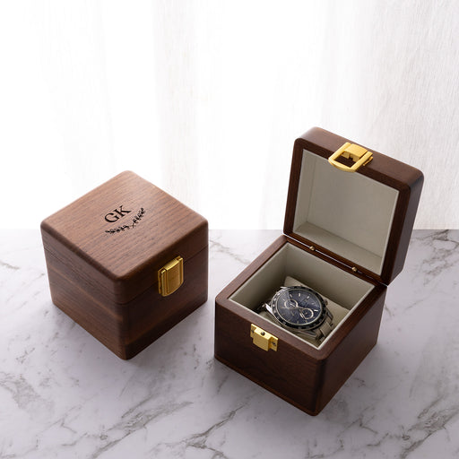 Personalised walnut watch box engraved with a custom name or message, featuring a soft velvet cushion for one watch.