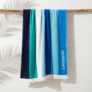Blue striped beach towel with white fringing and embroidered name
