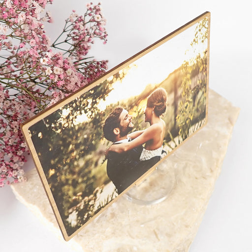 unique, customised special message on the back of a printed wedding photo on a wooden display frame.