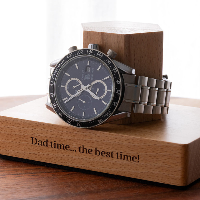 Custom beech wood watch holder with engraved base, designed to keep a favourite watch organised on a bedside table or dresser.