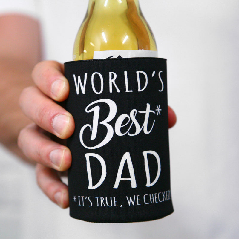 Black stubby holder printed with World’s Best Dad slogan on outdoor table
