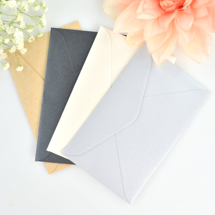 Gold, black, white and silver envelopes for wedding save the date magnets.