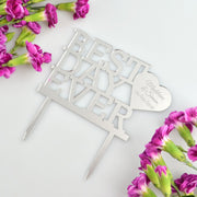 Black acrylic personalised wedding cake topper with names and date displayed on white cake